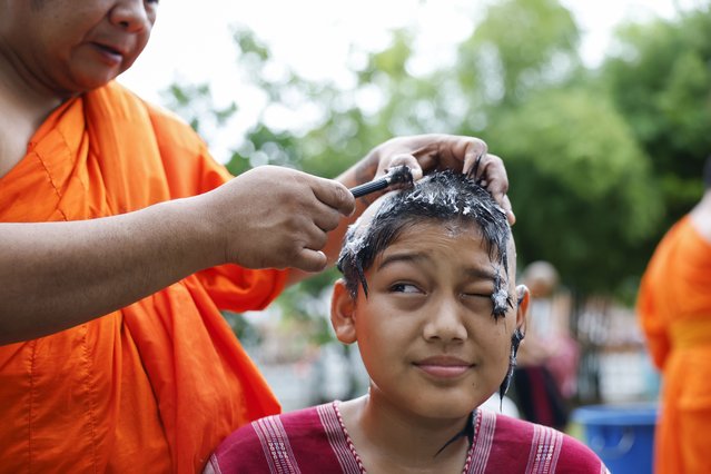 A hill tribe boy reacts as his hair is shaved by a Thai Buddhist monk during the head shaving rite of the 60th annual mass Buddhist monk ordination ceremony for hill tribe men and youngsters at Wat Benchamabophit Dusitwanaram, also known as the Marble Temple, in Bangkok, Thailand, 27 June 2025. A total of 196 hill tribe males – 97 men and 99 boys – from northern Thailand were ordained as Buddhist monks and novices in the 60th annual mass ordination ceremony at Wat Benchamabophit in Bangkok. The event is part of a national project, launched in 1965, aimed at spreading the Buddha’s Dharma to promote knowledge, wisdom, social and mental understanding, and improve welfare for hill tribe communities. The ceremony marks the start of Buddhist Lent, which begins this year on 11 July, and also honors the Thai King’s 73rd birthday on 28 July. During Lent, monks remain in one place to meditate and pray, while laypeople may give up meat or alcohol and observe other ascetic practices. In Thailand, it is traditional for Buddhist men to become monks at some point in their lives. (Photo by Rungroj Yongrit/EPA)