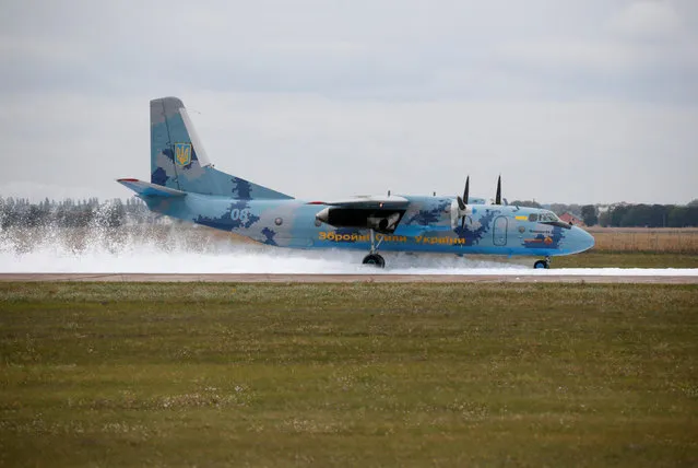 A Ukrainian military aircraft An-26 lands on a foam carpet as part of a rescue training exercise at Boryspil International Airport outside Kiev, Ukraine, September 27, 2016. (Photo by Valentyn Ogirenko/Reuters)