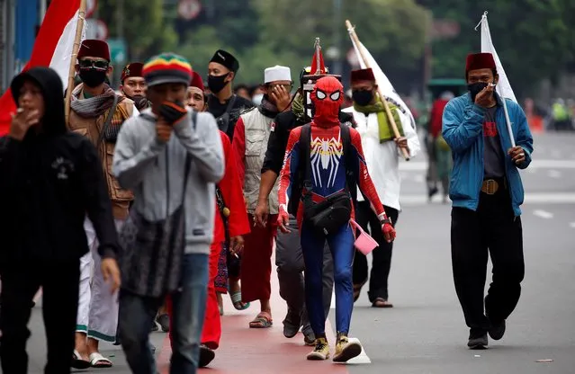 A man wearing a spider-man costume walks on the main road to join a protest against the new so-called omnibus law, in Jakarta, Indonesia, October 13, 2020. (Photo by Willy Kurniawan/Reuters)