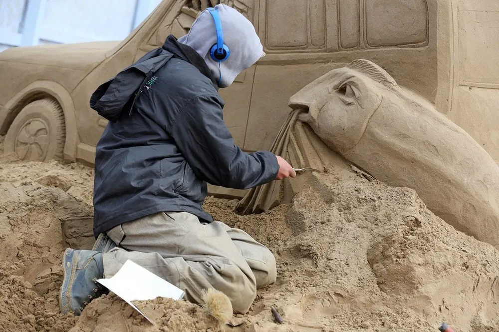 Sculptors Place the Finishing Touches to Their Hollywood Themed Sand Sculptures