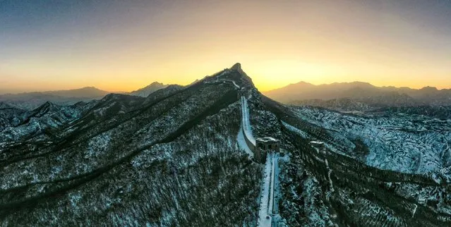 This aerial photo taken on February 19, 2023 shows snow scenery of the Simatai section of the Great Wall at sunrise in Beijing, capital of China. (Photo by Cai Yang/Xinhua/Alamy Live News)