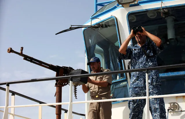 Members of Libyan coastguard stand guard on a ship as they help forces allied with the U.N.-backed government fighting Islamic State militants, off the coast of Sirte, Libya October 6, 2016. (Photo by Hani Amara/Reuters)