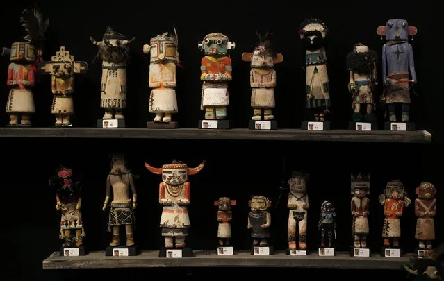Kachina dolls made by the Native American Hopi and Zuni tribes are displayed at the Drouot auction house in Paris before auction, December 15, 2014. The Hopi, some of whose 18,000 members continue to follow a traditional way of life farming on three isolated mesas, believe the bright, mostly fabric masks are imbued with the spirits of divine messengers. (Photo by Christian Hartmann/Reuters)