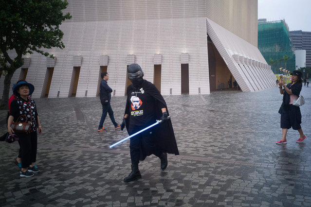 A man wears a “May the Force Day” shirt and carries a “light sabre” as he marks “Star Wars Day”, upon which fans celebrate the George Lucas films, in Hong Kong on May 4, 2018. (Photo by Anthony Wallace/AFP Photo)