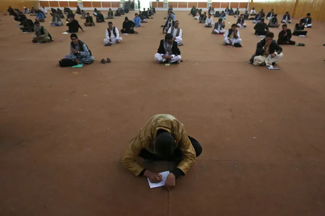 Afghan men sit in an exam to join Afghan National Army in Herat, Afghanistan, 29 October 2015. Afghan national security forces took over full responsibility for the country's security on 01 January 2015, as NATO-led coalition forces ended their 13-year-old active combat mission and started a new phase providing training, advice, and assistance, however, the country has since experienced an increase in attacks. (Photo by Jalil Rezayee/EPA)