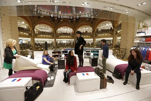 Six hand-picked shoppers prepare to sleep overnight in the Galeries Lafayette department store, as part of a special event on the eve of the start of winter sales, in Paris, January 6, 2015. (Photo by Charles Platiau/Reuters)