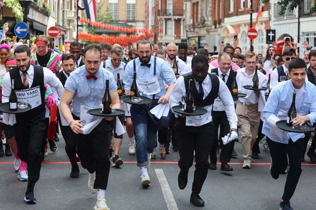 People participate in the Soho Waiter's Race at the Soho Village Fete, central London on Sunday, July 21, 2024. (Photo by Peter Tarry/The Times)