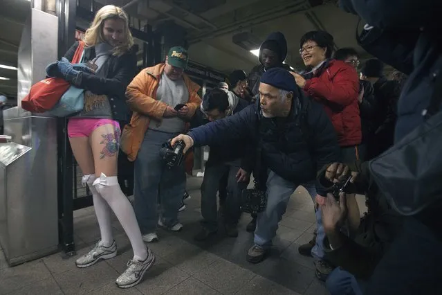 People take photos of a participant taking part in the “No Pants Subway Ride” in the Manhattan borough of New York January 11, 2015. (Photo by Carlo Allegri/Reuters)
