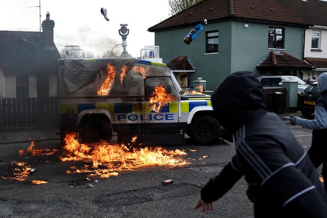 Dissident republicans throw petrol bombs at an armoured police car after holding an anti-Good Friday Agreement rally on the 25th anniversary of the peace deal, in Londonderry, Northern Ireland on April 10, 2023. (Photo by Clodagh Kilcoyne/Reuters)