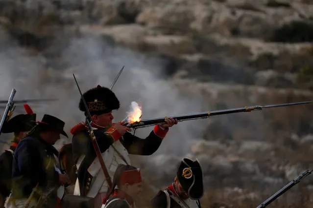 Napoleonic French re-enactors fire on Maltese defence positions during a re-enactment of the French invasion of Malta in 1798, at Mistra Bay outside Mellieha, Malta June 6, 2018. (Photo by Darrin Zammit Lupi/Reuters)