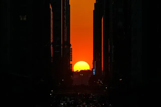 A view of the sunset from 42nd street during the “Manhattanhenge” on May 29, 2023 in New York, United States. (Photo by Lokman Vural Elibol/Anadolu Agency via Getty Images)