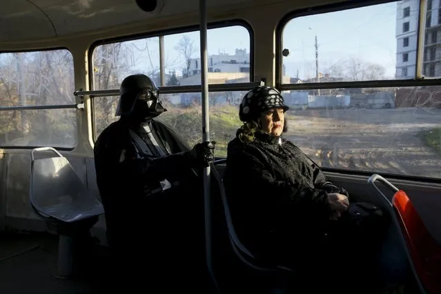 Darth Mykolaiovych Vader, who is dressed as the Star Wars character Darth Vader, poses for a picture as he rides on a tram in Odessa, Ukraine, December 3, 2015. (Photo by Valentyn Ogirenko/Reuters)