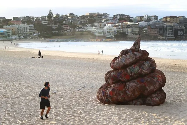 A sculpture titled “Plastic pile of sh!t, 2023” presented by Better Packaging Co. is seen on display at Bondi Beach on June 05, 2023 in Sydney, Australia. The four-metre-high sculpture is made out of recycled plastic and resembles human feces. The sculpture is designed to draw attention to the amount of plastic that's dumped in the world's oceans every 30 seconds. (Photo by Lisa Maree Williams/Getty Images)
