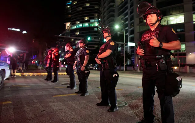 Police officers stand guard during a protest against U.S. President-elect Donald Trump in Miami, Florida, U.S. November 11, 2016. (Photo by Javier Galeano/Reuters)
