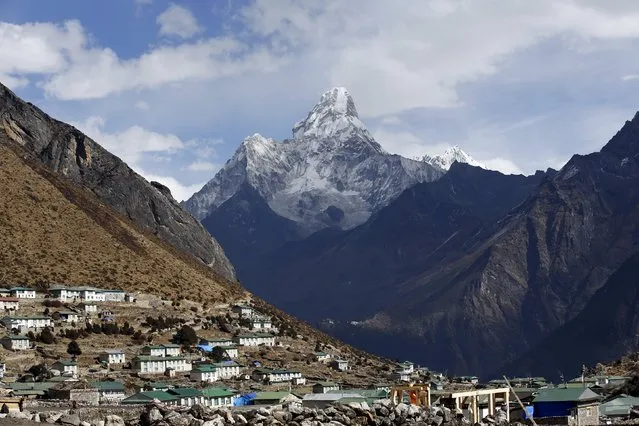 Mount Ama Dablam is seen behind Khumjung a typical Sherpa village in Solukhumbu District also known as the Everest region, in this picture taken November 30, 2015. (Photo by Navesh Chitrakar/Reuters)