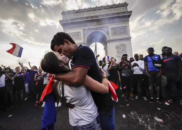 French supporters celebrate at the Arc de Triomphe on top of the Champs-Elysees after France won the 2018 World Cup during the FIFA World Cup 2018 final match between France and Croatia in Paris, France, 15 July 2018. (Photo by Ian Langsdon/EPA/EFE)
