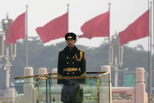 A Chinese paramilitary policeman stands watch on Tiananmen Square near the Great Hall of the People where the closing session of the Chinese People's Political Consultative Conference (CPPCC) is held in Beijing on Wednesday, March 10, 2021. (Photo by Ng Han Guan/AP Photo)