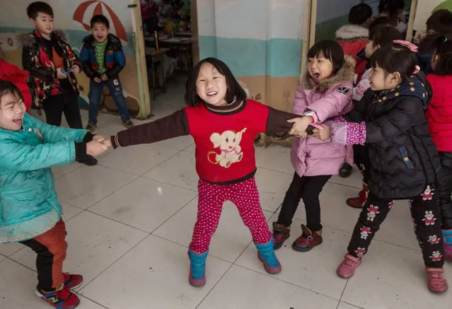 Chinese students who are children of migrants play around as they take a break at an un-official school on December 18, 2015 in Beijing, China. (Photo by Kevin Frayer/Getty Images)