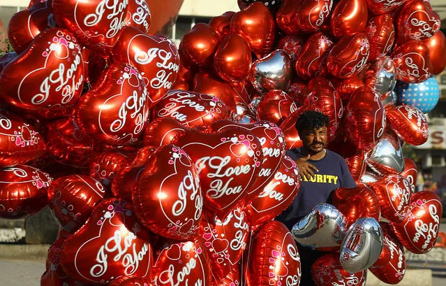 A vendor sells balloons on Valentine's Day in Karachi, Pakistan, 14 February 2021. Valentine's Day, which is celebrated worldwide on 14 February each year, is considered to be un-Islamic in Pakistan. (Photo by Shahzaib Akber/EPA/EFE)