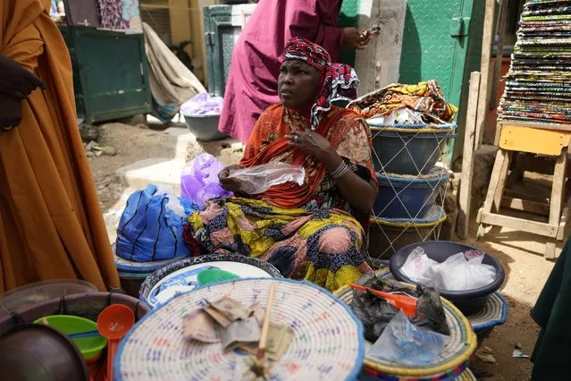 A woman sells cow milk at a market in Kano, Nigeria, Thursday, July 13, 2023. (Photo by Sunday Alamba/AP Photo)