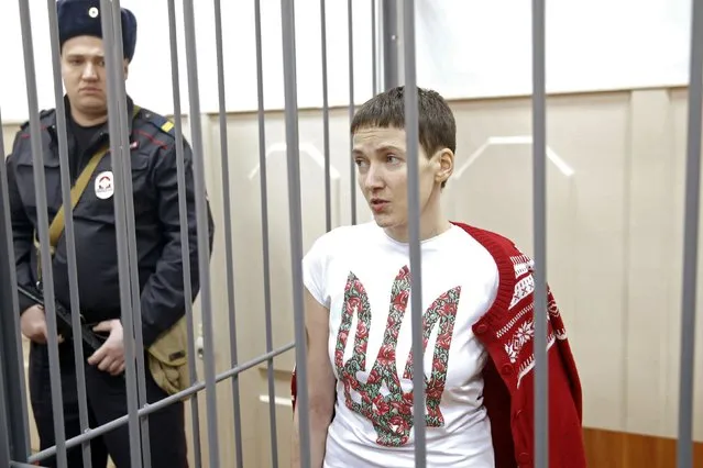 Ukrainian army pilot Nadezhda (Nadia) Savchenko looks out from a defendant's cage during a hearing at the Basmanny district court in Moscow February 10, 2015. Savchenko is accused in Russia of providing coordinates for a mortar attack in east Ukraine in which two Russian journalists were killed last summer. (Photo by Maxim Zmeyev/Reuters)