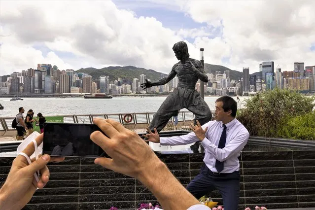 Fans gather in front of the statue of martial artist Bruce Lee to commemorate the 50th anniversary of his death in Hong Kong, Thursday, July 20, 2023. (Photo by Louise Delmotte/AP Photo)