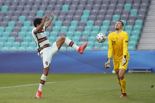 Portugal's Tiago Tomas, left, fails to scores a goal in front Switzerland goalkeeper Anthony Racioppi during the Euro U21 group D soccer match between Switzerland and Portugal at Stozice stadium in Ljubljana, Slovenia, Wednesday, March 31, 2021. (Photo by Darko Bandic/AP Photo)