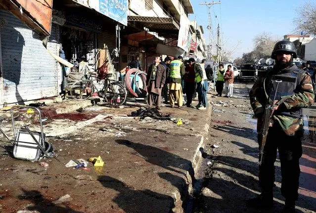 A Pakistani paramilitary soldier stands at the site of a bomb blast near a polio vaccination centre in Quetta on January 13, 2016. At least 15 people were killed in a blast apparently targeting police outside a polio vaccination centre in the southwestern Pakistani city of Quetta on January 13, according to officials. (Photo by Banaras Khan/AFP Photo)