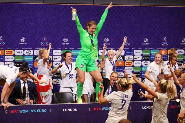 Mary Earps dance on the Press Conference table as players of England interrupt the Press Conference with Sarina Wiegman, Manager of England, after the UEFA Women's Euro 2022 final match between England and Germany at Wembley Stadium on July 31, 2022 in London, England. (Photo by Sarah Stier – UEFA/UEFA via Getty Images)