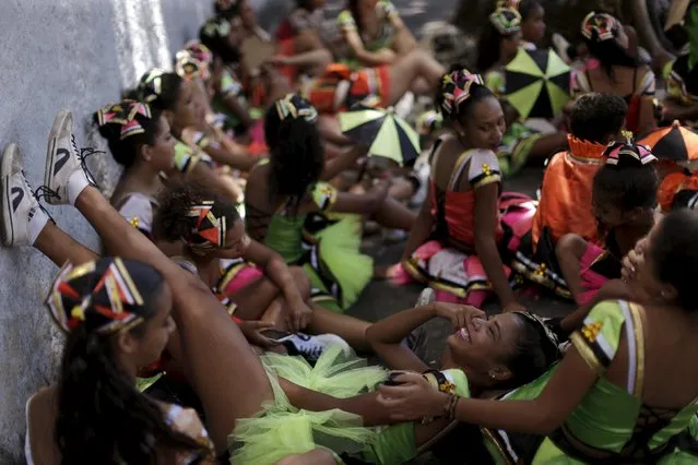 Revellers react during the “Burial of the Mosquito” carnival block parade in Olinda, Brazil February 5, 2016. The parade takes place annually during the Brazilian Carnival and informs residents and tourists about the risks of the Aedes aegypti mosquitos. (Photo by Ueslei Marcelino/Reuters)