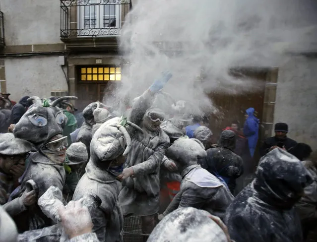 Revellers participate in a flour fight during the “O Entroido” festival in Laza village, Spain February 8, 2016. (Photo by Miguel Vidal/Reuters)