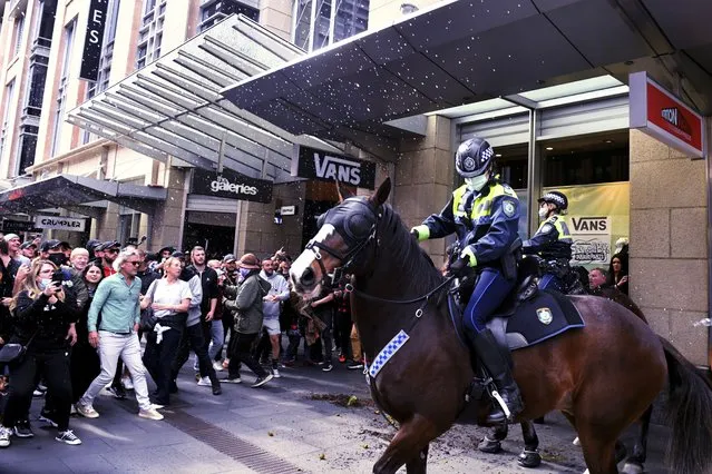 Protesters and mounted police clash at Sydney Town Hall during a “World Wide Rally For Freedom” anti-lockdown rally in Sydney, Saturday, July 24, 2021. (Photo by Mick Tsikas/AAP Image via AP Photo)