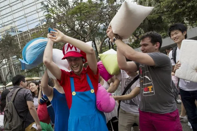 People take part in the International Pillow Fight Day at Hong Kong's financial Central district April 4, 2015. (Photo by Tyrone Siu/Reuters)