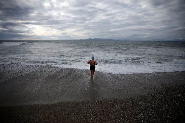 An Orthodox faithful braves the cold waters during Epiphany day celebrations in the southern suburb of Faliro in Athens, Greece January 6, 2017. (Photo by Alkis Konstantinidis/Reuters)