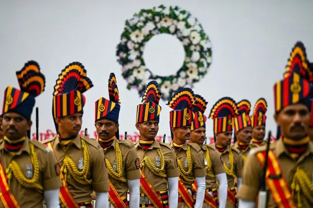 Policemen in ceremonial attire pay respect at the Police Memorial to commemorate 15th anniversary of the 2008 Mumbai militant attacks, in Mumbai on November 26, 2023. (Photo by Punit Paranjpe/AFP Photo)