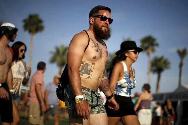 People walk through the Coachella Valley Music and Arts Festival in Indio, California April 10, 2015. (Photo by Lucy Nicholson/Reuters)