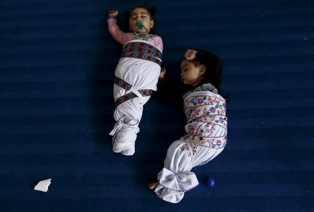 Sikh twins sleep during the Baisakhi festival at Panja Sahib shrine in Hassan Abdel April 13, 2015. (Photo by Caren Firouz/Reuters)