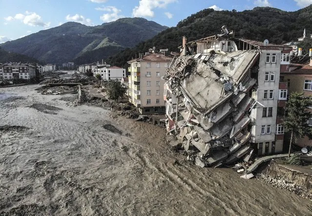An aerial photo shows destroyed buildings after floods and mudslides killed about two dozens of people, in Bozkurt town of Kastamonu province, Friday, August 13, 2021. Heavy rainfalls that pounded the Black Sea coastal provinces of Bartin, Kastamonu, Sinop and Samsun on Wednesday caused the flooding that demolished homes and bridges and swept away cars. (Photo by Ismail Coskun/IHA via AP Photo)