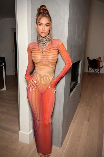 American actress Mgena Fox has shown off her curves while posing in a sheer orange in the last decade of July 2023. The Transformers actress, 36, flashed her boobs as she went braless in the skintight mesh garment.dress. (Photo by jennakristina/Instagram)