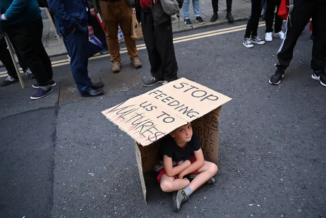 Patrick Rogerson, 6, sits inside a shelter he made from a sign reading “stop feeding us to vultures” during a protest against the rising cost of housing and rent at a rally called “Winter of Housing Discontent” in front of government buildings in Dublin, Ireland, September 15, 2021. (Photo by Clodagh Kilcoyne/Reuters)