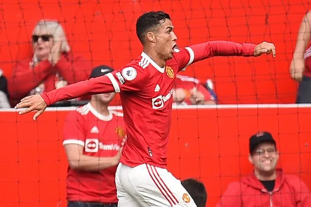 Manchester United's Portuguese striker Cristiano Ronaldo celebrates after scoring the opening goal of the English Premier League football match between Manchester United and Newcastle at Old Trafford in Manchester, north west England, on September 11, 2021. (Photo by Oli Scarff/AFP Photo)