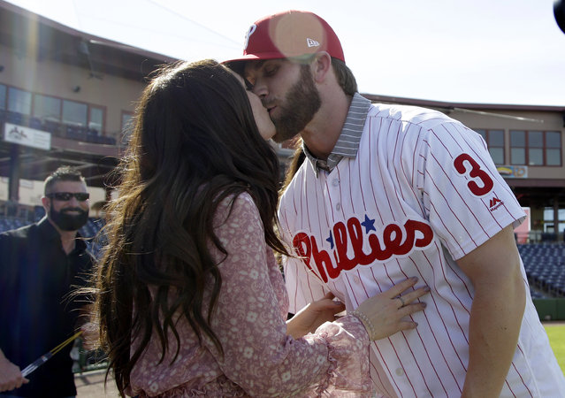 Bryce Harper, right, hugs his wife Kayla after being introduced as a Philadelphia Phillies player during a news conference at the team's spring training baseball facility, Saturday, March 2, 2019, in Clearwater, Fla. Harper and the Phillies agreed to a $330 million, 13-year contract, the largest deal in baseball history. (Photo by Lynne Sladky/AP Photo)