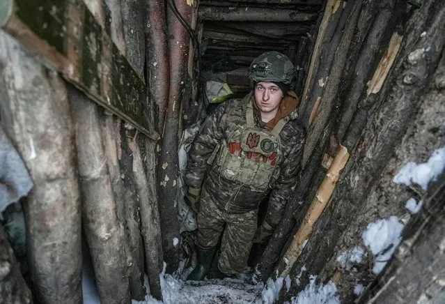 A Ukrainian serviceman of 2 battalion 92nd brigade with the call sign “Myron”, 21, is seen inside a dugout, amid Russia's attack on Ukraine, at a position near Bakhmut in Donetsk region, Ukraine on January 10, 2024. (Photo by Inna Varenytsia/Reuters)
