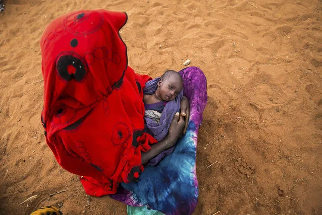 Sara Alisio and her one-month old child Molide Kelbi wait for food and water in the Warder district in the Somali region of Ethiopia, Saturday, January 28, 2017. Ethiopia is struggling to counter a new drought in its east that authorities say has left 5.6 million people in urgent need of assistance. (Photo by Mulugeta Ayene/AP Photo)