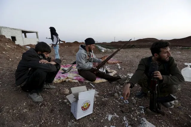 Rebel fighters from Jaysh al-Sunna sit in Tel Mamo village, in the southern countryside of Aleppo, Syria March 13, 2016. (Photo by Khalil Ashawi/Reuters)