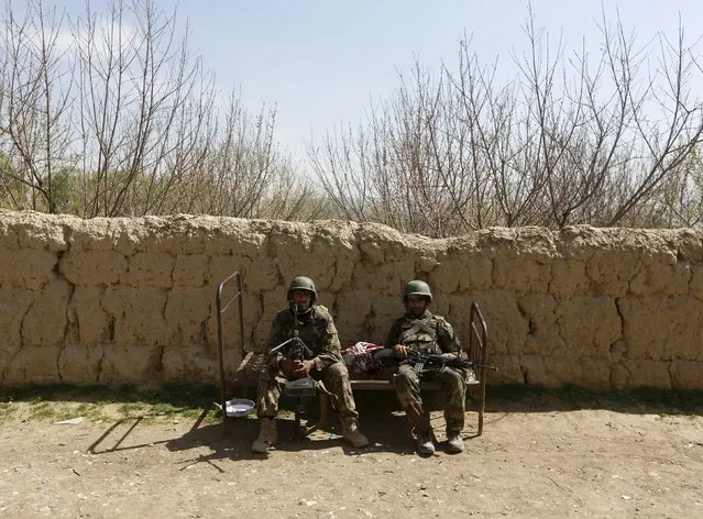 Afghan National Army (ANA) soldiers take a break after patrolling in Dand Ghori district of Baghlan province, Afghanistan March 15, 2016. (Photo by Omar Sobhani/Reuters)
