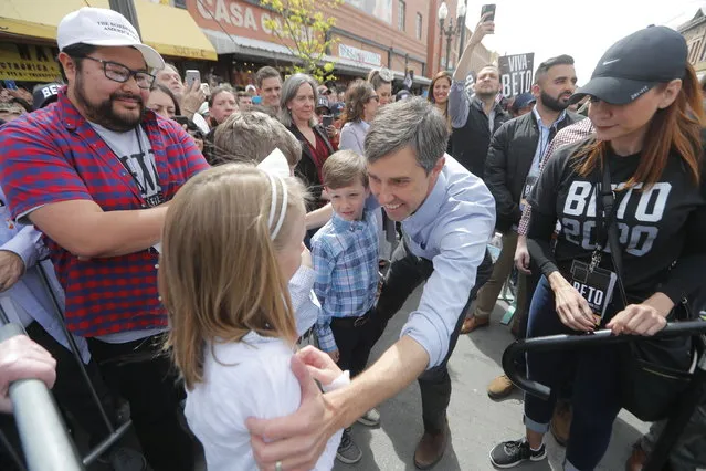 Democratic presidential candidate and former Texas congressman Beto O'Rourke, greets his daughter Molly, 10, son Ulysses, 12, and son Henry, 8, as he arrives at his presidential campaign kickoff in El Paso, Texas, Saturday, March 30, 2019. (Photo by Gerald Herbert/AP Photo)