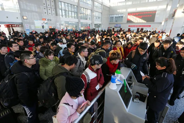 People wait to board trains on the last day of the Chinese Lunar New Year holidays, at a railway station in Lianyungang, Jiangsu province, China February 2, 2017. (Photo by Reuters/Stringer)