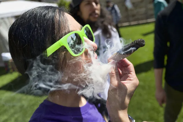  In this Friday, March 22, 2019 file photo, a participant takes a very smoky puff from a marijuana cigarette during at meet and greet at Tommy Chong's Live, Love, and Smoke Tour hosted by GreenTours in the Woodland Hills section of Los Angeles. U.S. retail sales of cannabis products jumped to $10.5 billion last year, a threefold increase from 2017, according to data from Arcview Group, a cannabis investment and market research firm. The figures do not include retail sales of hemp-derived CBD products. (Photo by Richard Vogel,/AP Photo/File)