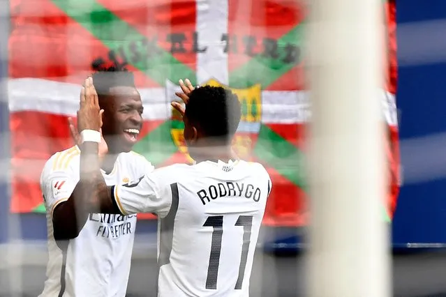 Real Madrid's Brazilian forward #07 Vinicius Junior (L) celebrates scoring the opening goal with Real Madrid's Brazilian forward #11 Rodrygo during the Spanish league football match between CA Osasuna and Real Madrid CF at El Sadar stadium in Pamplona on March 16, 2024. (Photo by Ander Gillenea/AFP Photo)
